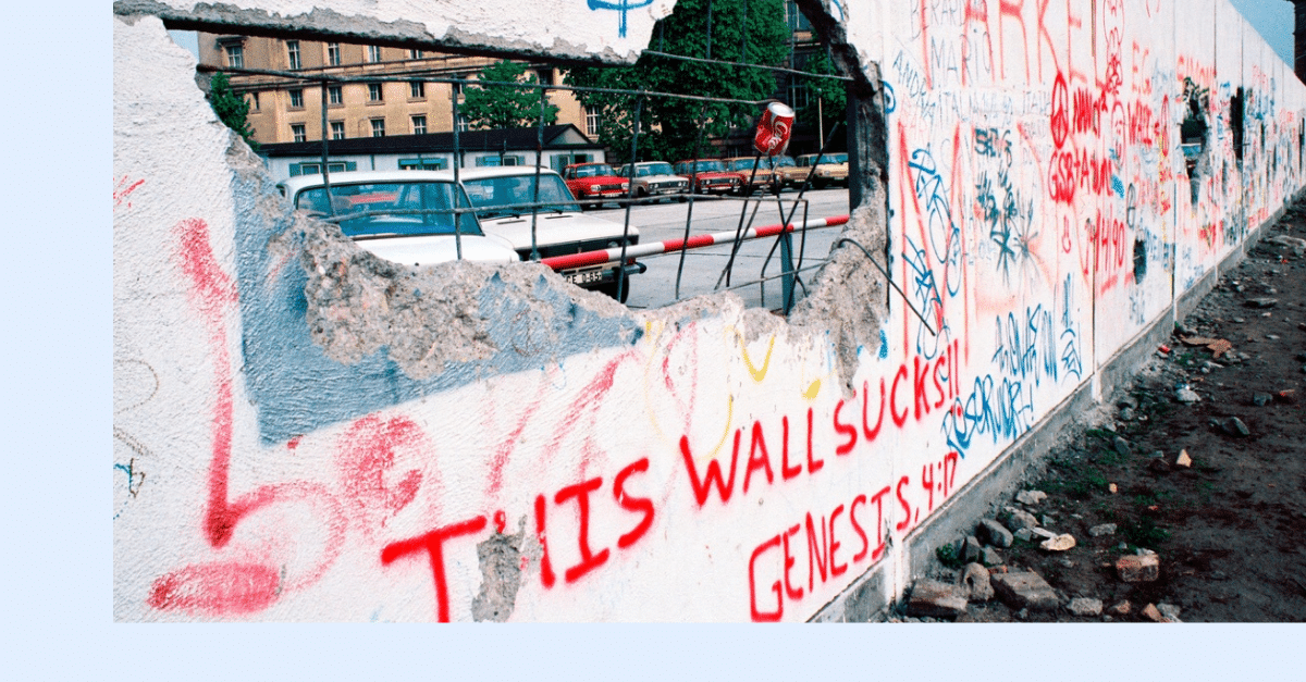 A section of the Berlin Wall with graffiti 'This Wall Sucks'.